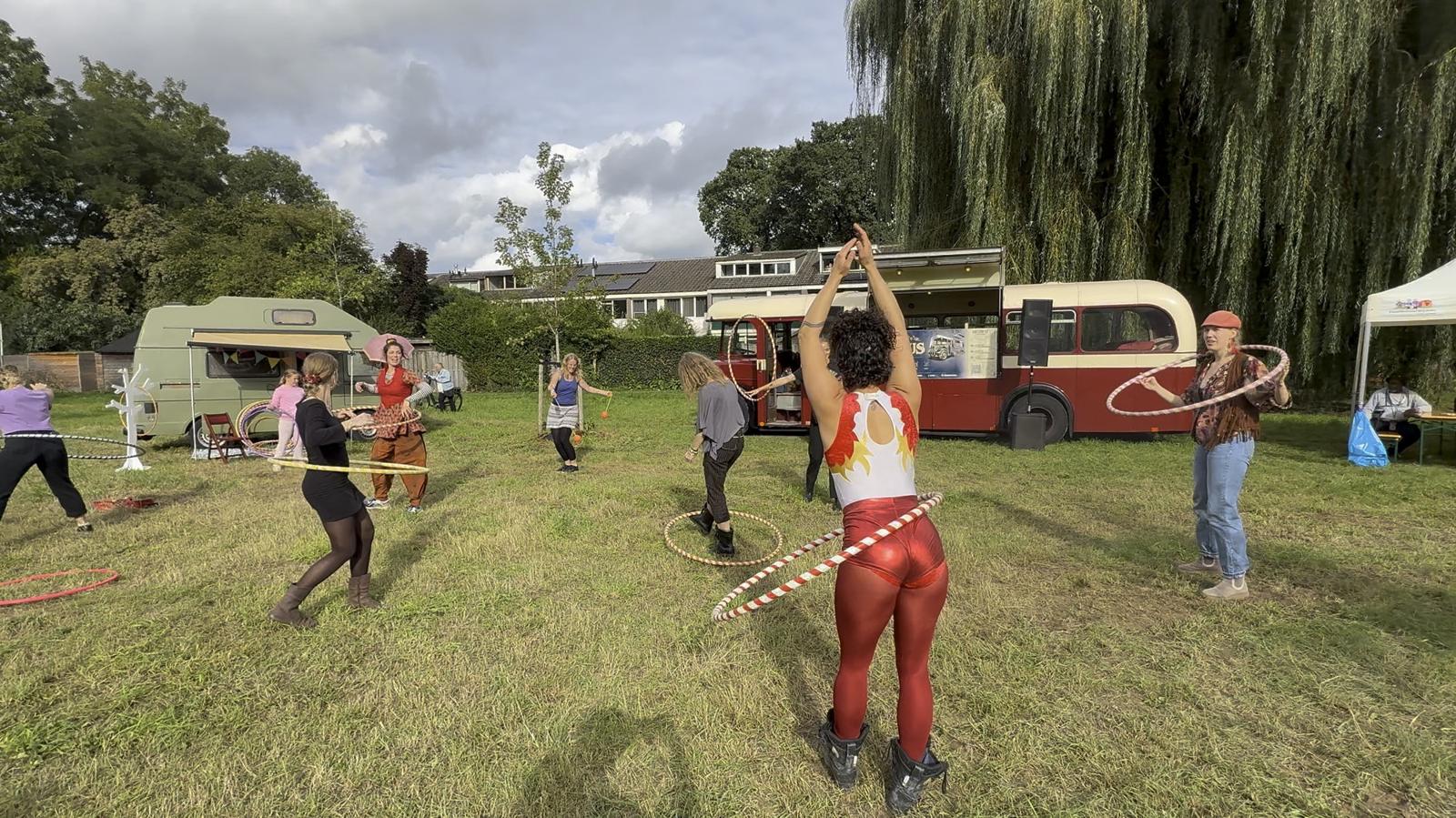 Hoepelartiesten voor de bus